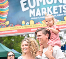 people in front of the Eumundi Markets sign